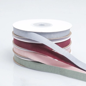 Rolls of high-quality velvet ribbon in muted colors for gift wrapping and DIY crafts