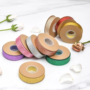 Glitter metallic ribbon rolls on kraft spools for DIY crafts and gift wrapping decoration