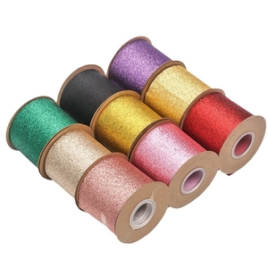 Nine rolls of colorful glitter ribbon for gift wrapping and DIY crafts on white background