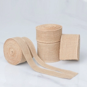 Set of four natural jute burlap ribbon rolls with rustic plain weave for DIY crafts