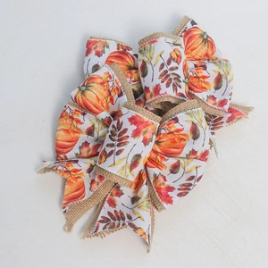 Detail of autumn burlap bow with pumpkin and maple leaf prints for holiday decor