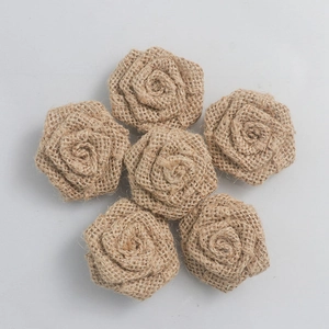 Detailed view of six handmade burlap rose flowers for rustic Christmas DIY craft decor