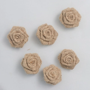 Detailed top view of six handmade burlap roses for rustic Christmas DIY decorations