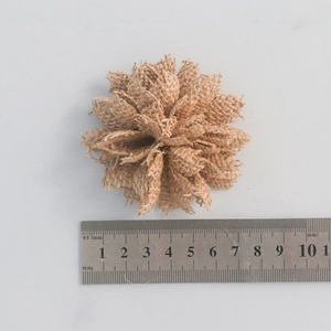 Handmade burlap rose decoration for Christmas with measuring scale shown on a gray surface