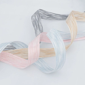 Close-up of semi-transparent striped polyester ribbons for gift wrapping and DIY crafts