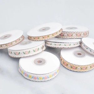 Floral embroidery ribbons set for DIY crafts and hair accessories on marble background
