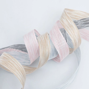 Close-up of multicolored striped polyester ribbons with metallic weave for gift wrapping