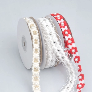 Detail of embroidered lace ribbons with pearls for DIY crafts and gift wrapping