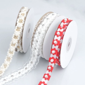Detail of embroidered plum blossom and pearl lace ribbons for DIY gift packaging