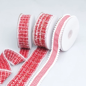 Close-up of red tweed and checkered ribbon rolls with fuzzy edges for DIY crafts