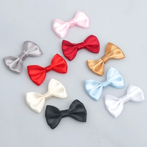 Close-up of nine colorful 2.5x4cm polyester satin bows for DIY crafts and gift packaging