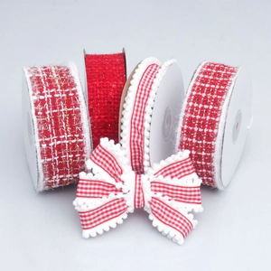 Close-up of red and white plaid tweed ribbons and pom-pom trim for DIY bow hair accessories