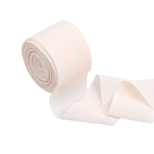Elastic skin-colored crepe bandage roll with breathable texture for support and medical use