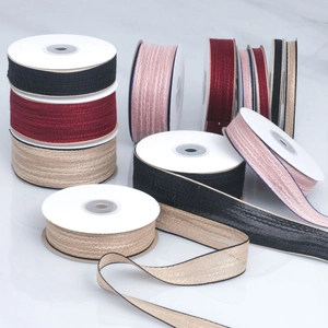 Detailed close-up of colorful cotton ribbon rolls with textured weave for DIY crafts