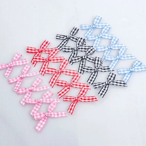 Detail of plaid ribbon bows in pink red black and blue for DIY clothing accessories