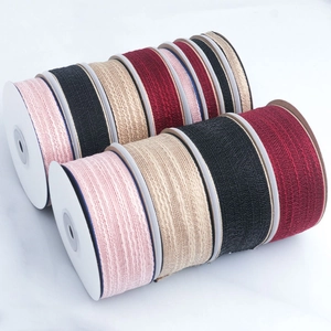 Close-up of textured cotton ribbons in multiple colors on a marble surface