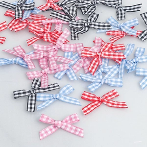 Detailed view of colorful plaid fabric bows in red, blue, and pink for DIY sewing projects