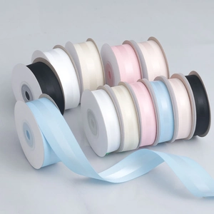 Close-up of multicolored grosgrain ribbons in rolls showing textured ribbed surface