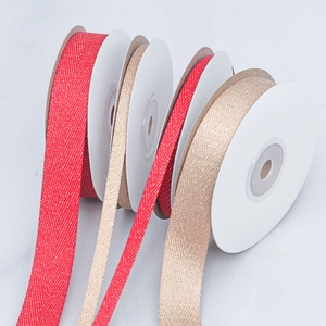 Detailed macro view of herringbone metallic ribbon in red and gold for gift wrapping decor