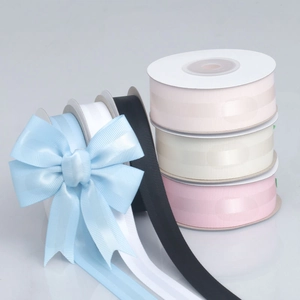 Grosgrain ribbon assortment with a light blue bow on spools for gift wrapping and wedding decor