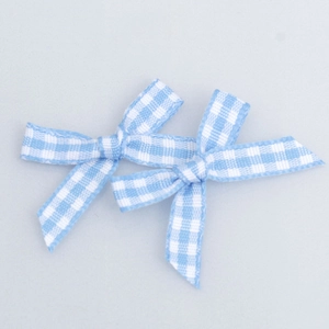 Detail of light blue and white gingham ribbon bows for DIY gift wrapping and crafts