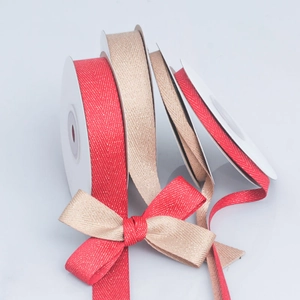 Detail of red and champagne gold herringbone ribbons with metallic glitter for DIY crafts