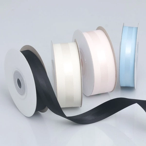 Detailed macro of grosgrain ribbons with satin center stripe on rolls in four colors