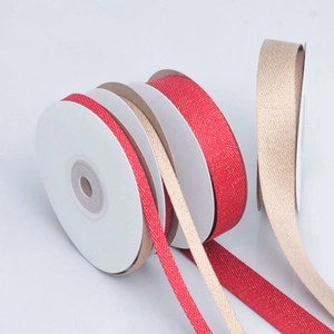 Red and champagne herringbone ribbon with gold metallic glitter on white spools