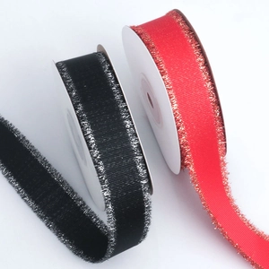Detail of red ribbon with gold glitter edges and black ribbon with silver glitter edges