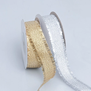 Detailed close-up of gold and silver metallic ribbons with frayed edges on white spools