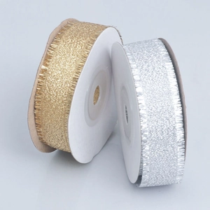 Metallic fringed ribbon in gold and silver colors on rolls for gift wrapping decoration