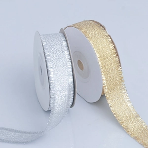 Metallic gold and silver fringe ribbon rolls with frayed edges for gift wrapping