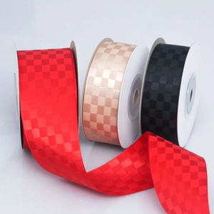 Detail of red, champagne and black checkered ribbons with satin woven texture