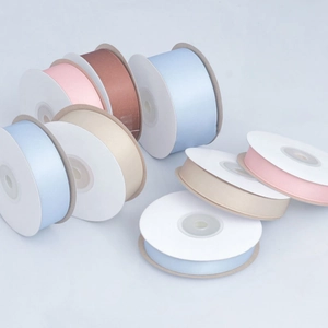 Detailed close-up of matte polyester cotton ribbons in pastel colors for gift wrapping