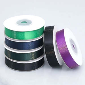 Close-up of assorted glitter gradient ribbons in rolls for gift wrapping and DIY crafts