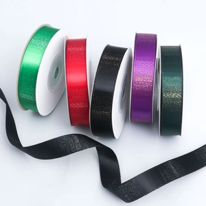 Macro shot of assorted colorful polyester ribbons with shimmering metallic glitter texture