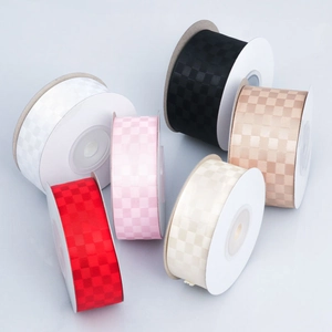 Polyester checkered ribbons in red, black, pink and beige on white plastic spools