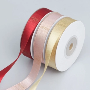 Gradient ribbon rolls in red, pink, and gold with metallic horizontal texture for gift wrapping