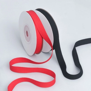 Macro shot of red and black herringbone cotton tapes with clear V-shaped weaving texture