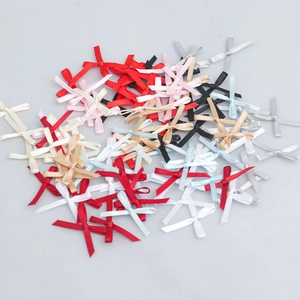 Detailed view of colorful mini polyester satin bows for DIY apparel and crafts