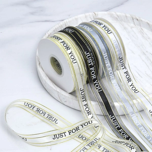 Detail of luxury gift ribbons with gold edges and Just For You printed text for baking
