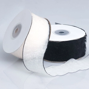 Detail of white and black plush fringe ribbons with fine texture for gift wrapping