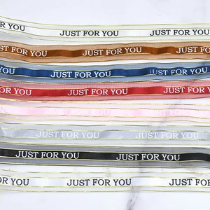 Detail of colorful sheer organza ribbons with gold edges and Just For You printed text