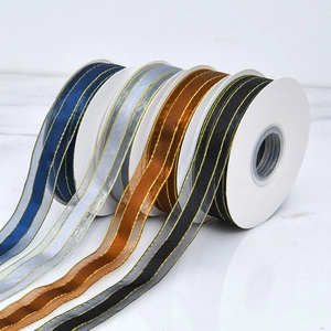Detail of assorted gold-edged ribbon rolls for luxury cake and gift packaging