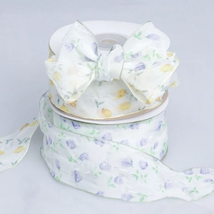 Detailed view of floral pleated ribbon roll with purple flowers and green edges