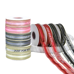 Satin ribbons with gold edges and Just For You text on white marble tray background