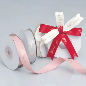 Detailed view of 1.5cm polyester satin ribbons with gold Thank You text for gift wrapping