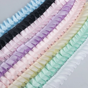 Parallel layout of pleated polyester ribbons in multiple colors for garment decoration