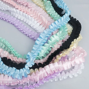 Macro view of pleated polyester satin ribbons in various colors for DIY crafts