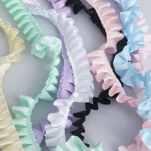 Close-up of pleated polyester satin ribbons in various pastel colors for DIY sewing crafts